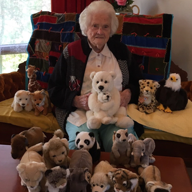 Beatrice with her collection of adopted plushes