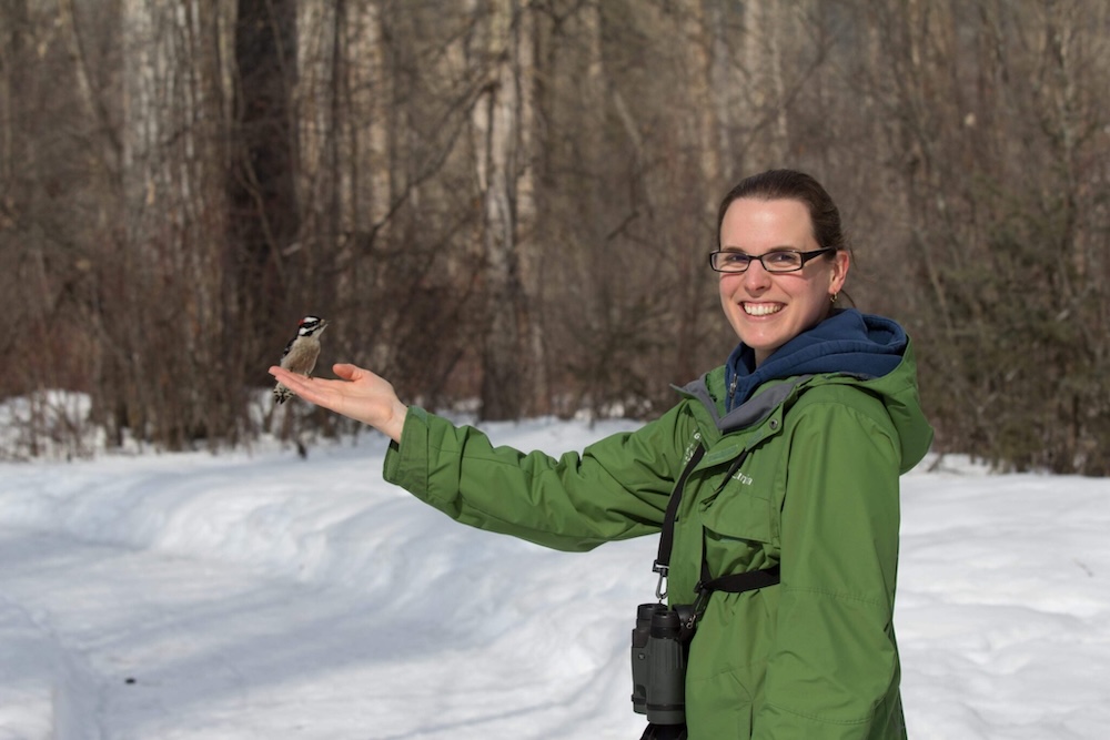 Legacy donor Vicki Smith with a downy woodpecker in Cottonwood Island Park, in Prince George, B.C.